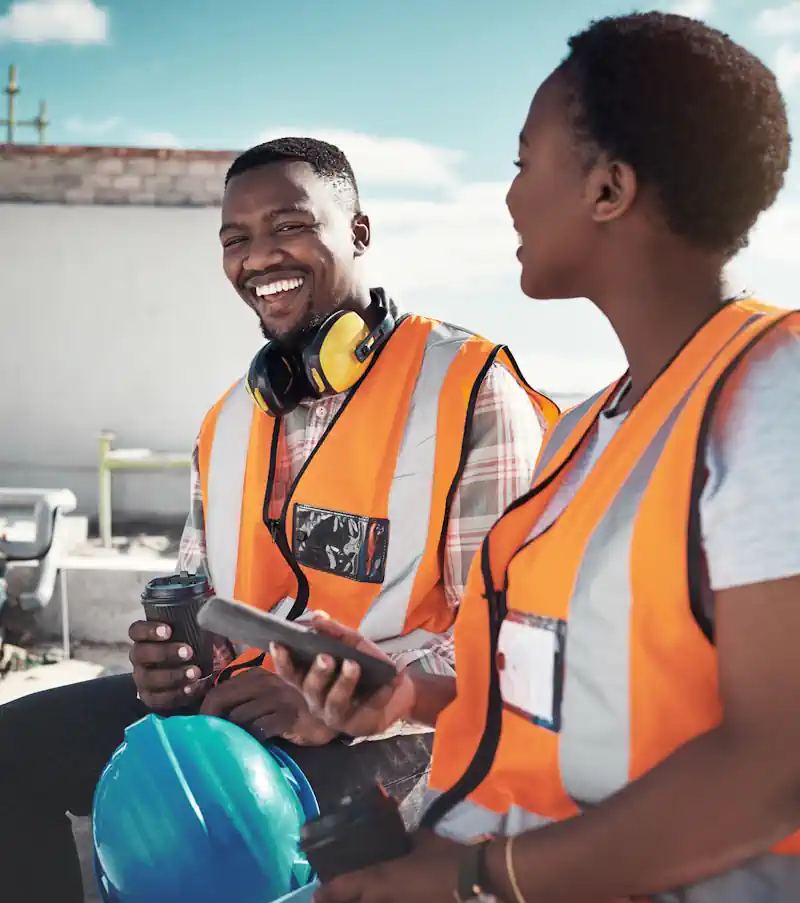 Two Bafokeng SME team members reviewing their business on a tablet on site
